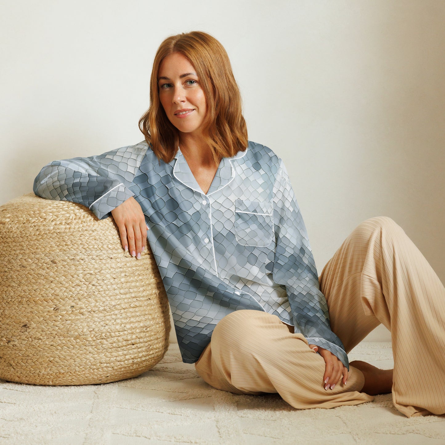 Woman wearing a blue, long sleeve pajama top with a blue tile print from Rosenmay Studio