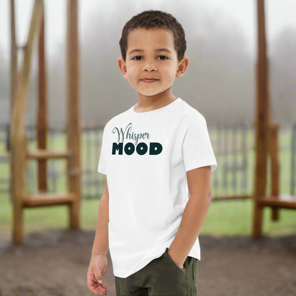 Boy wearing a white cotton tshirt with the text, whisper mood, design by Rosenmay Studio